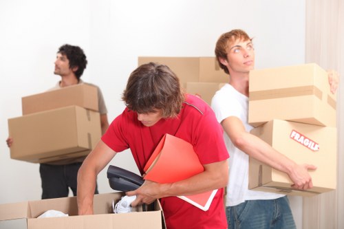 Two movers handling furniture carefully during a removal job