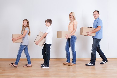 A local moving team handling boxes in a Crystal Palace property